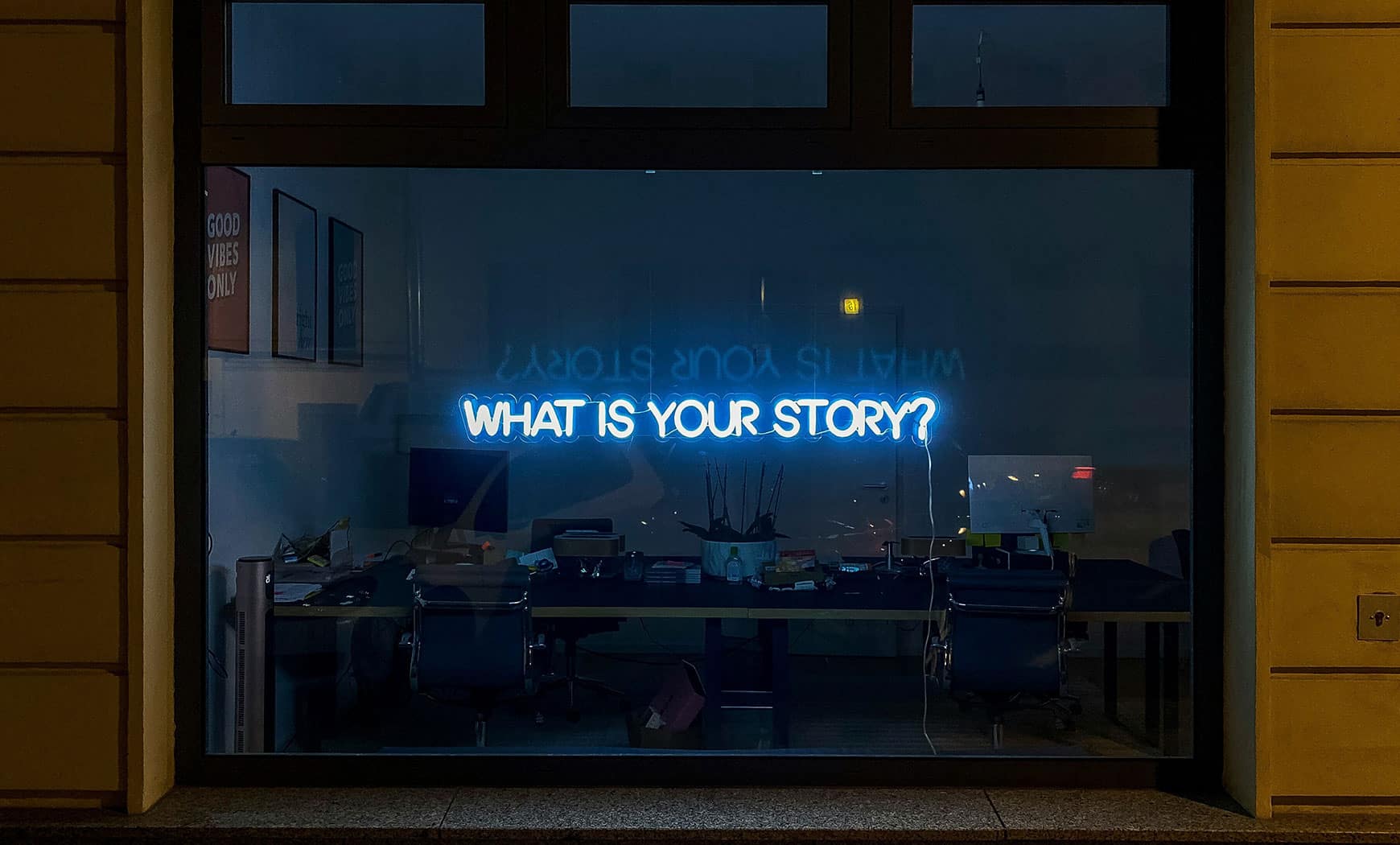 a neon sign reads "what is your story?" Meant to represent an article on effective copywriting for brand success.